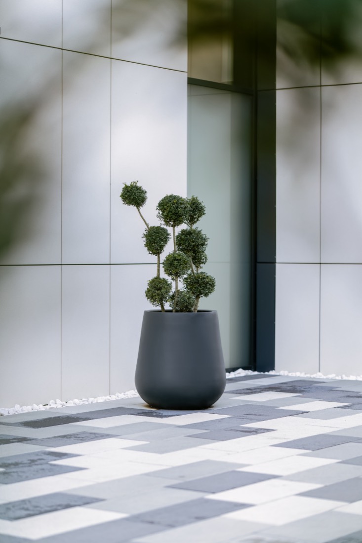 Smooth dark planter at a hotel entrance, Istog